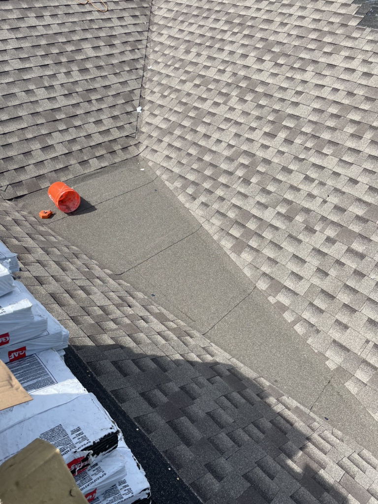 Close view of shingle roof planes meeting at a valley